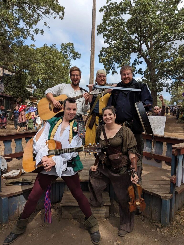 The five members of the band posed together on stage with their instruments.